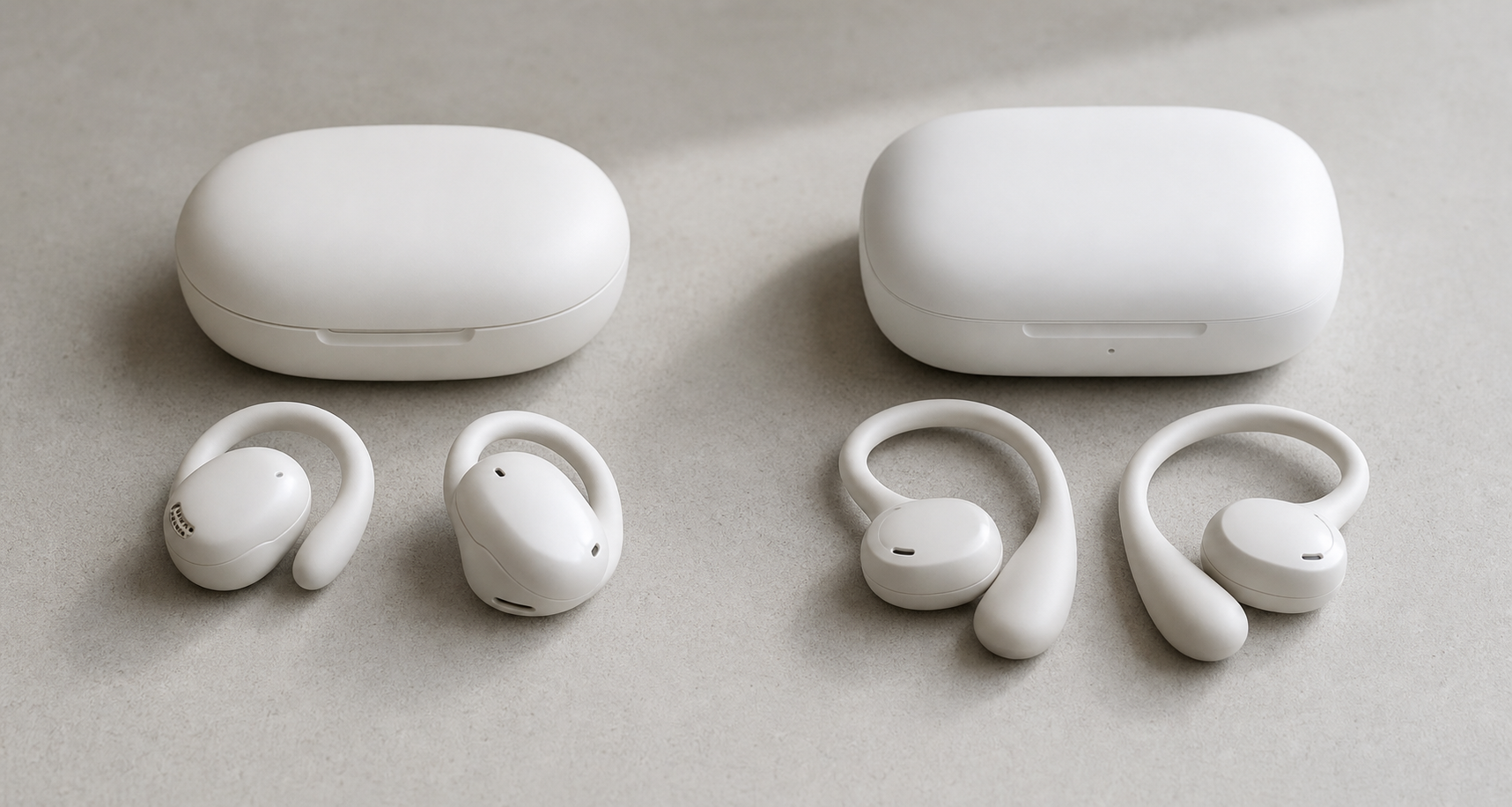 Two generations of white wireless earbuds and charging cases side by side