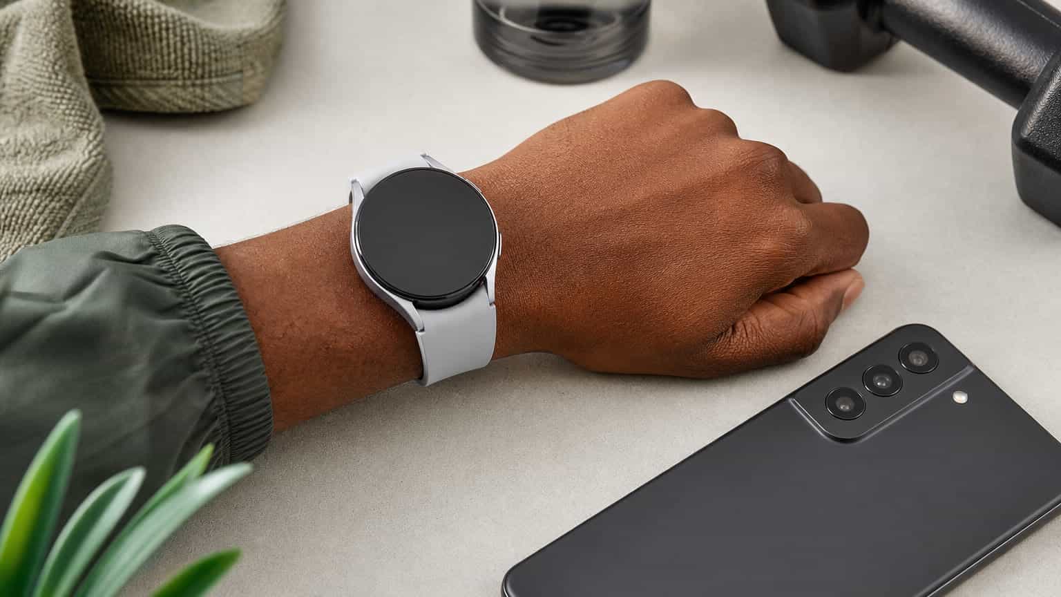 Samsung-style smartwatch on a wrist beside an Android phone for a Nigerian buying guide