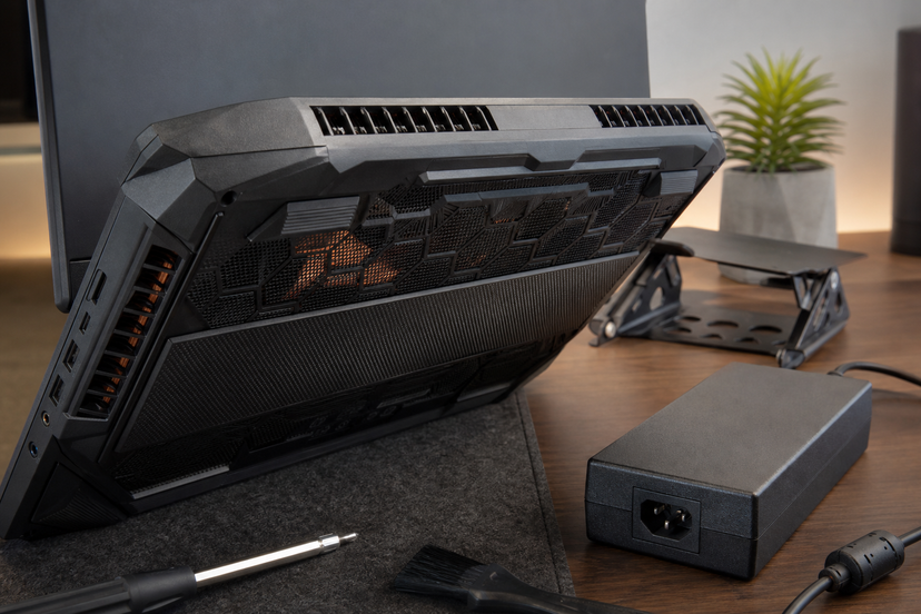 Gaming laptop vents and power adapter showing thermal and charger checks