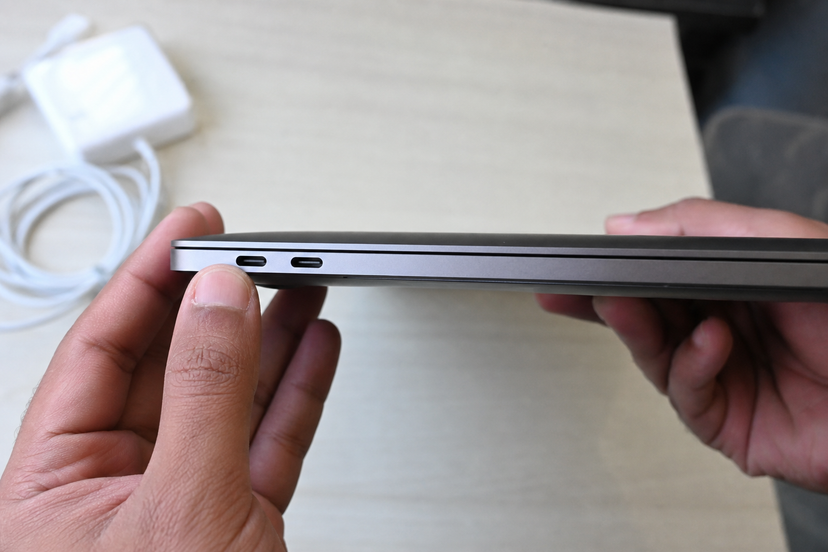 Close-up of USB-C ports on a used 13-inch laptop during inspection