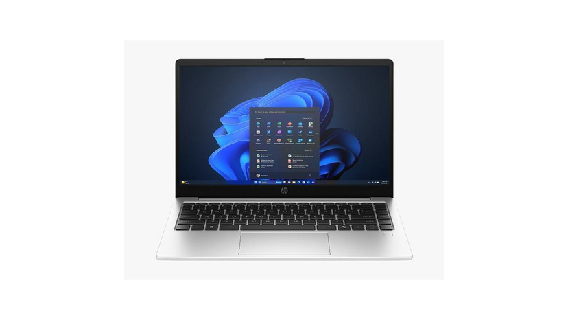 Laptop side profile beside charger and common work accessories