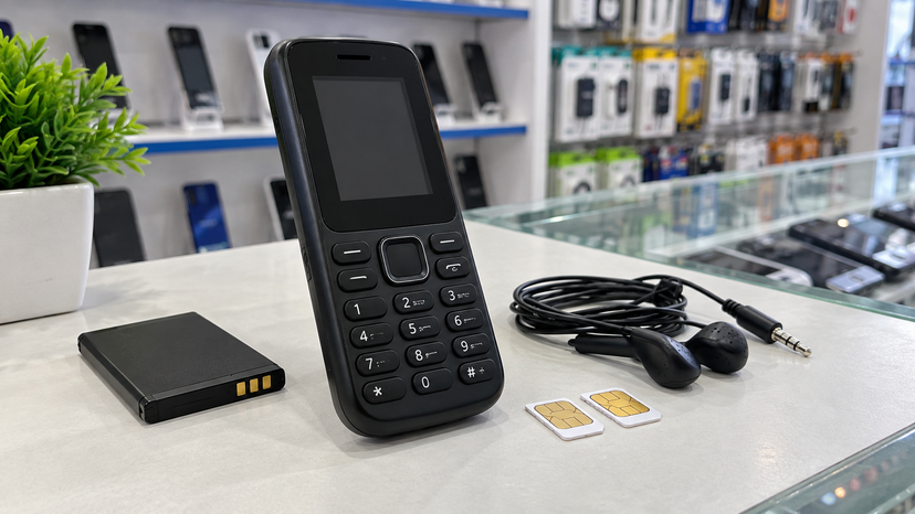 Close view of a compact keypad feature phone with dual SIM and FM radio buying cues